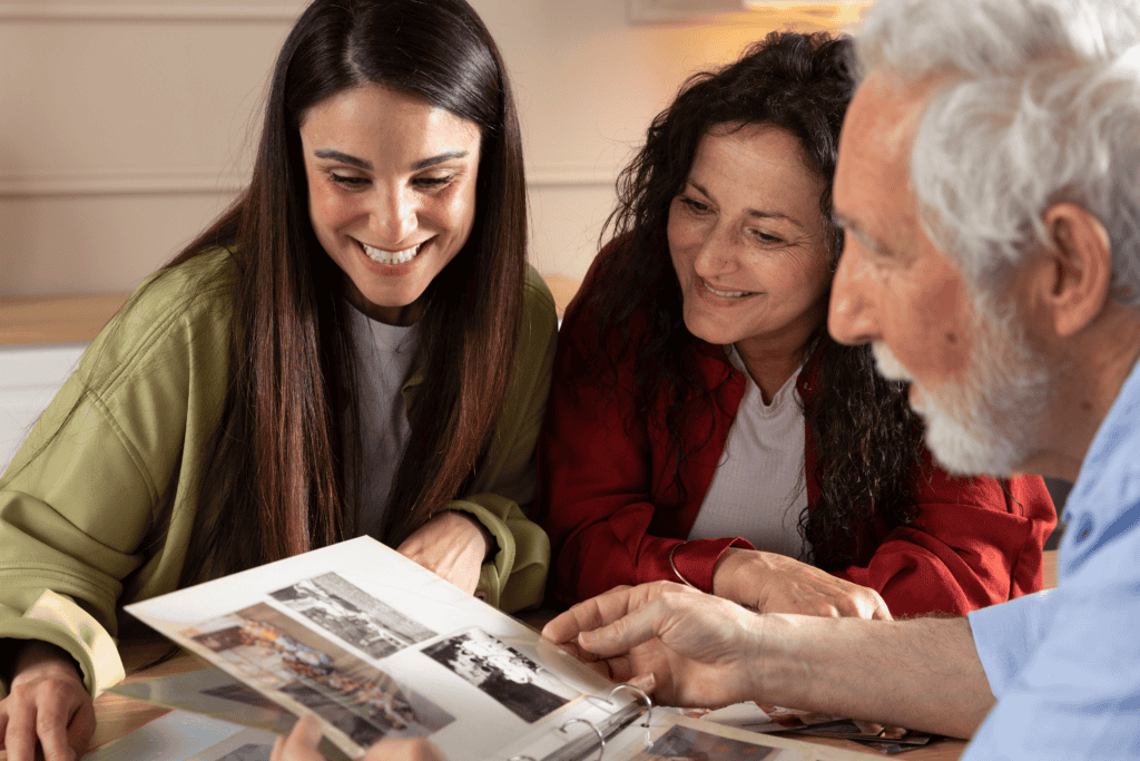 A Family Admiring Photographs from their Photo Albums